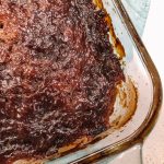 Baked Elk Meatloaf in a glass 9x5 loaf pan topped with a savoury sweet sauce