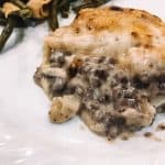 Green beans and scalloped potatoes served on a white plate