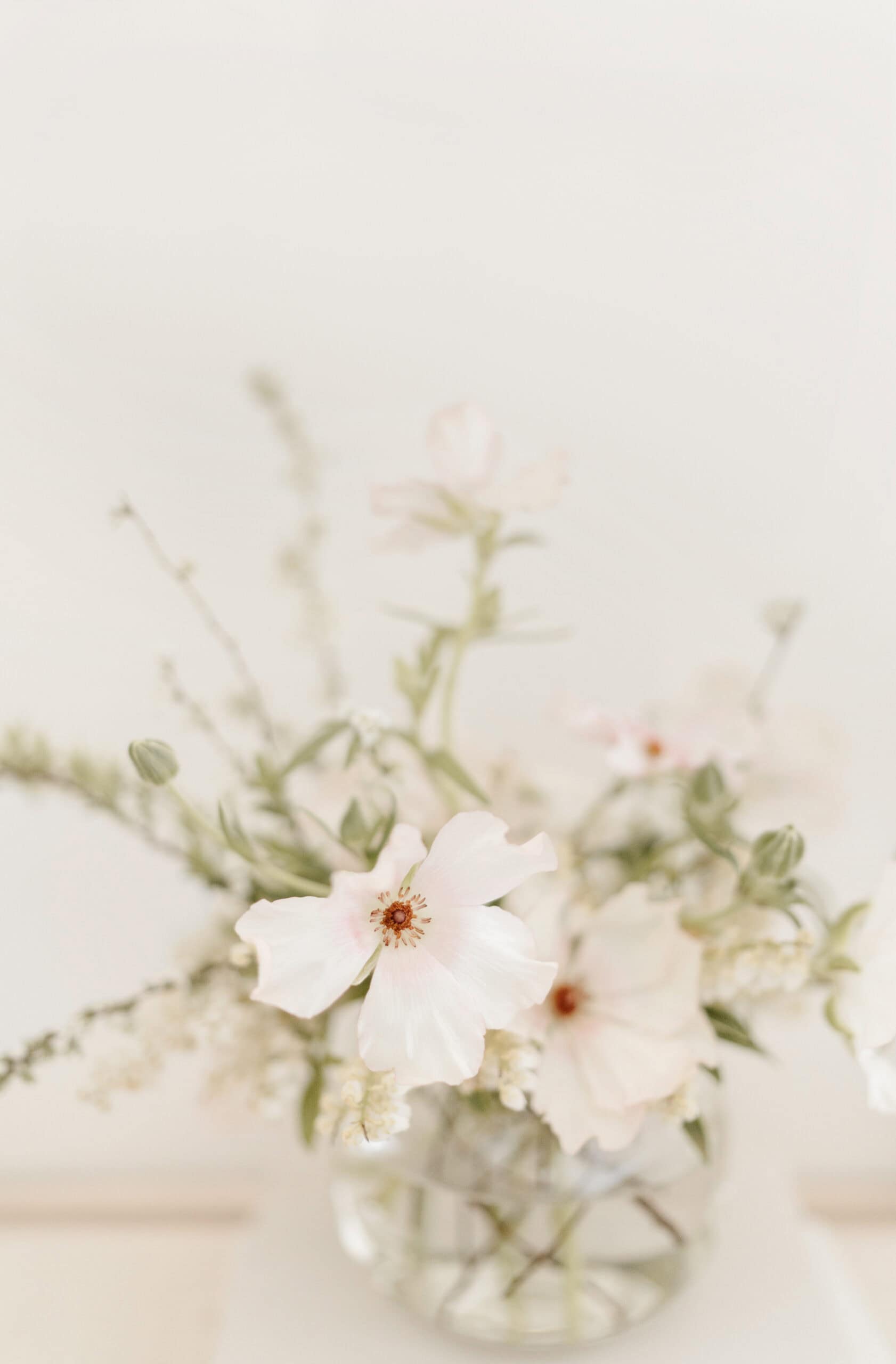 white flowers with greenery in a vase